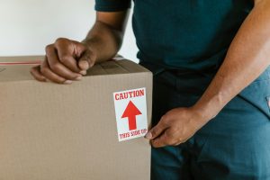A moving truck with "Good Life Movers" text parked in front of a house.