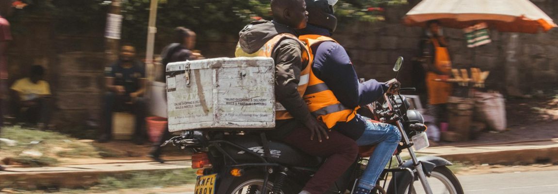 Professional movers carrying furniture boxes into a moving truck in Nairobi.